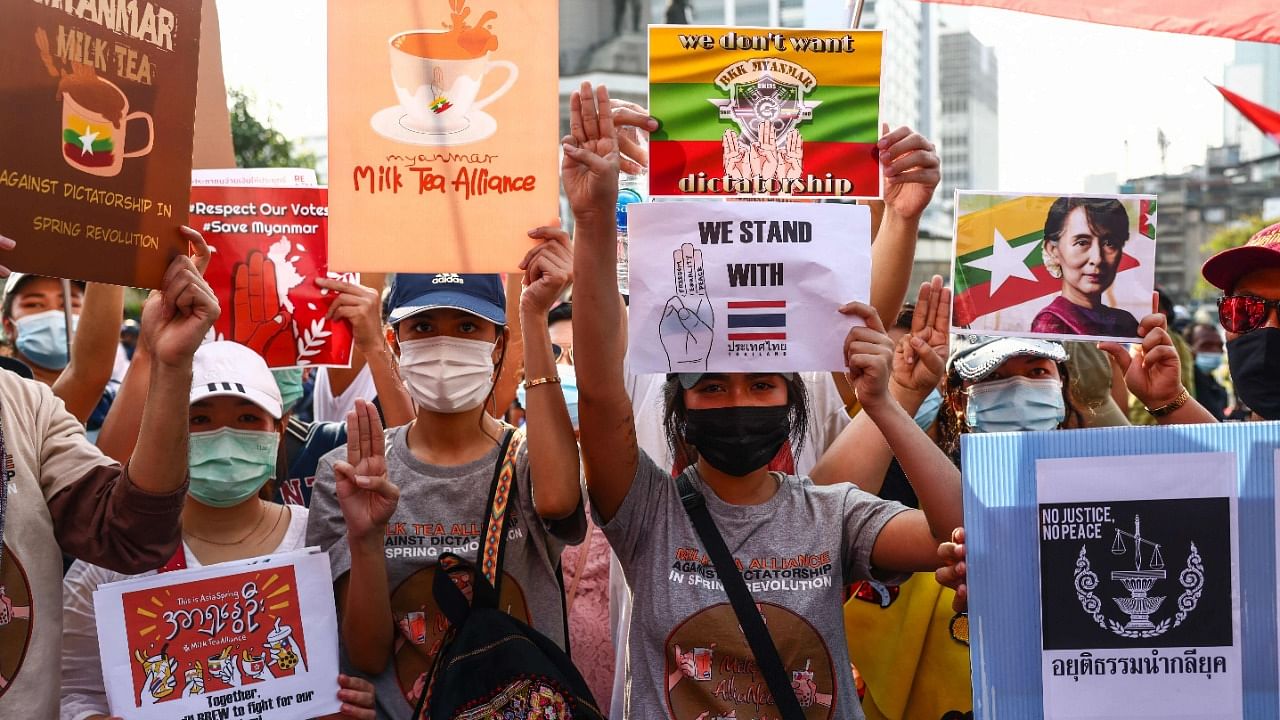 Pro-democracy protesters holds signs relating to the "Milk Tea Alliance" and the current situation in Myanmar in Bangkok. Credit: AFP Photo