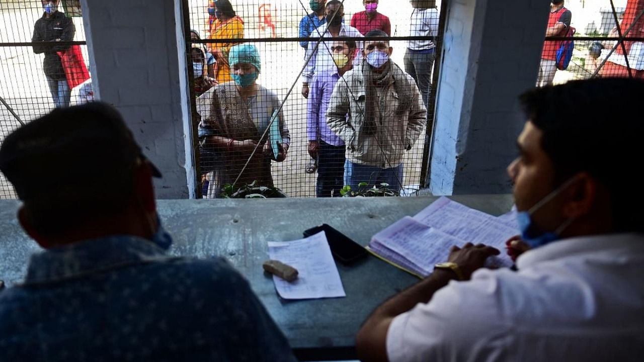 People register their names to get tested for the Covid-19 coronavirus at a testing centre in Allahabad. Credit: AFP.