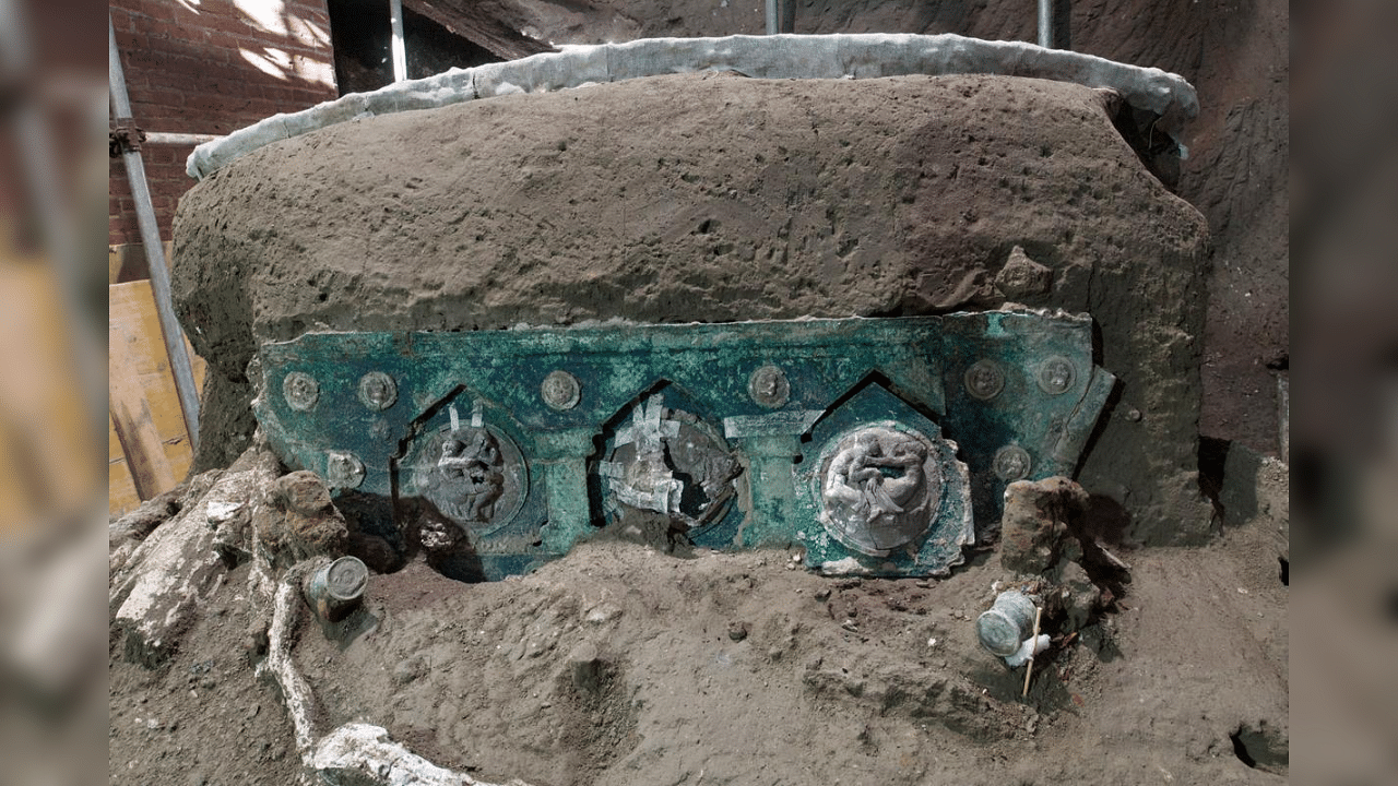  A photo handout on February 27, 2021 by the archaeological park of Pompeii shows a detail of a large Roman four-wheeled ceremonial chariot after it was discovered near the The archaeological park of Pompeii. Credit: AFP Photo