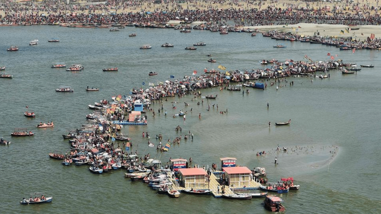 An aerial view shows Hindu devotees at the Sangam area,, the confluence of rivers Ganges, Yamuna, and the mythical Saraswati, on the auspicious day of 'Maghi Purnima' during the annual traditional fair Magh Mela Festival in Allahabad on February 27, 2021. Credit: PTI Photo