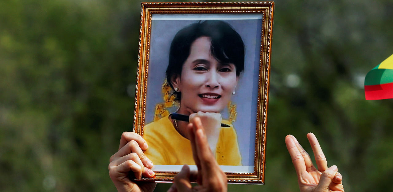 A person holds a picture of leader Aung San Suu Kyi as Myanmar citizens protest against the military coup in front of the UN office in Bangkok. Credit: Reuters Photo