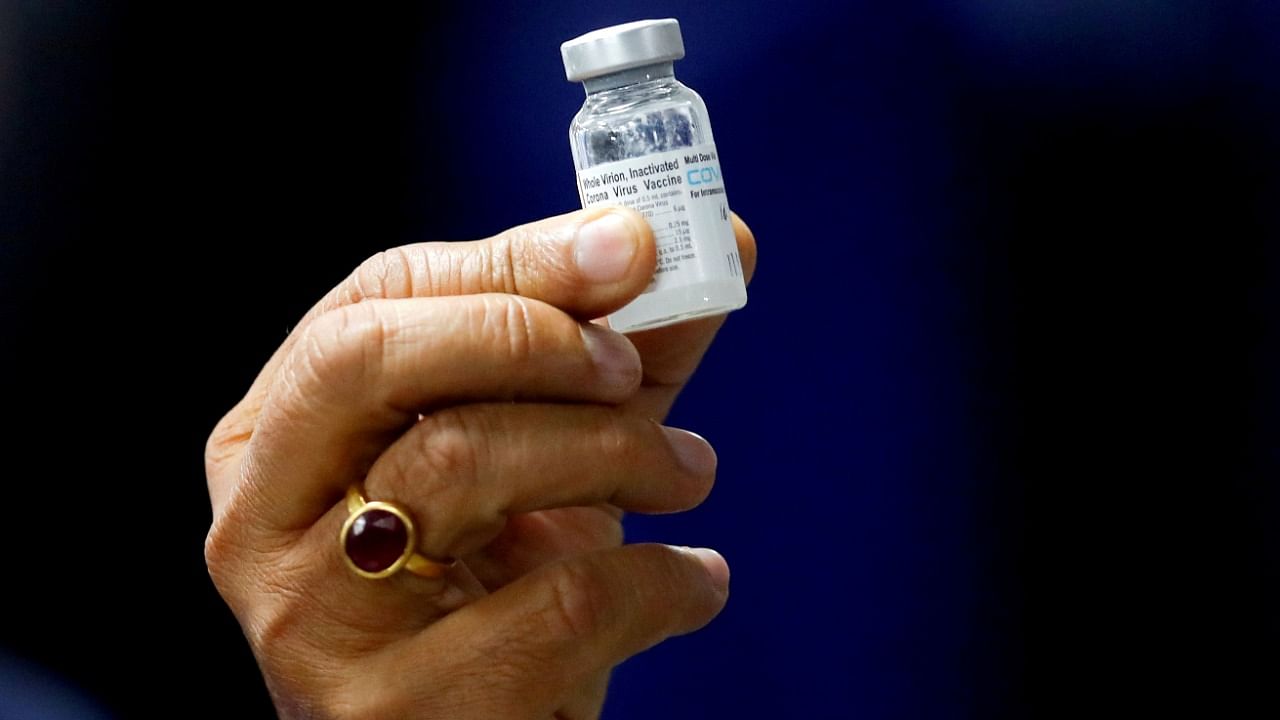 Health Minister Harsh Vardhan holds a dose of Bharat Biotech's Covid-19 vaccine called Covaxin, during a vaccination campaign at AIIMS hospital in New Delhi on January 16, 2021. Credit: Reuters File Photo
