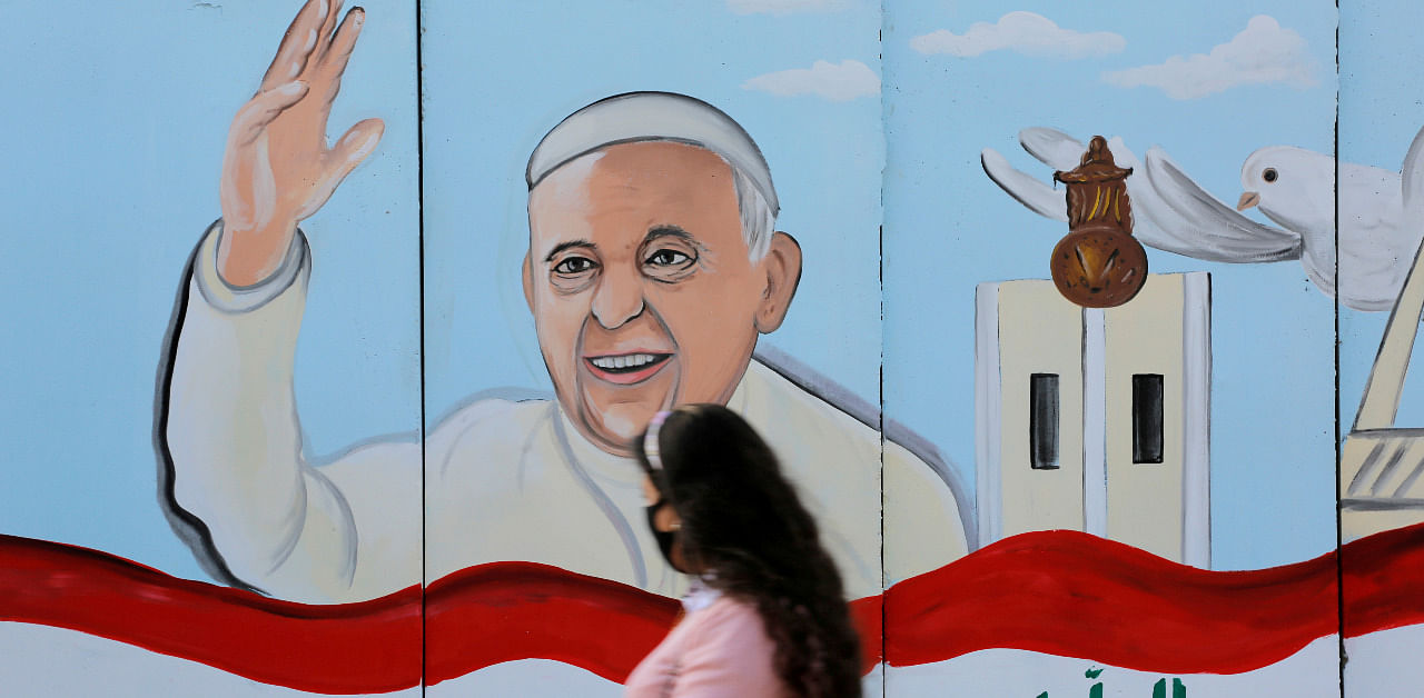 A mural of Pope Francis is seen on the wall of a church upon his upcoming visit to Iraq. Credit: Reuters Photo