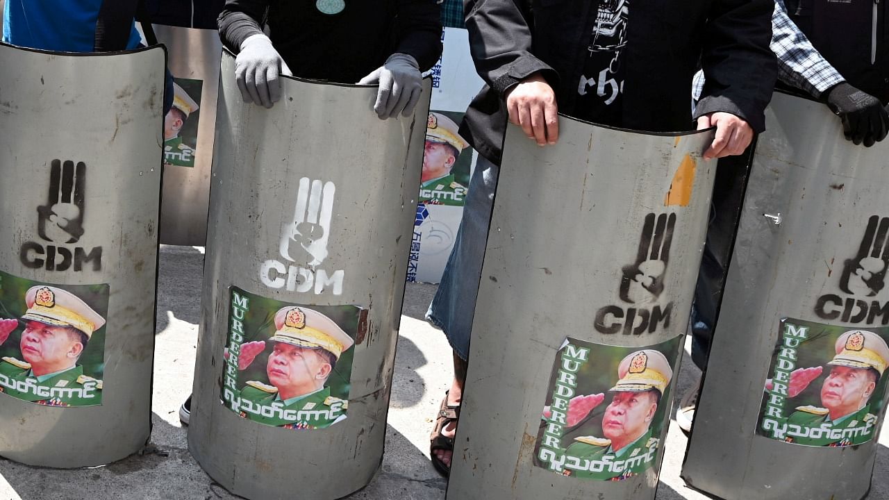 Demonstrators hold shields with attached pictures of Myanmar's military junta leader General Min Aung Hlaing, during a protest against the military coup in Yangon, Myanmar, March 1, 2021. Reuters Photo