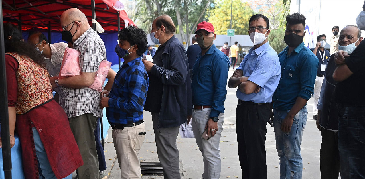 People stand in a queue to register for a Covid-19 vaccine at Max hospital in New Delhi. Credit: AFP Photo