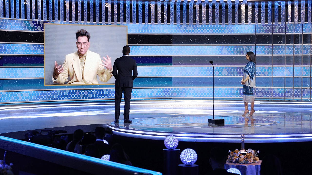Dan Levy accepting the Best Musical/Comedy Series award for "Schitt's Creek" via video from Sterling K. Brown and Susan Kelechi Watson at the 78th Annual Golden Globe Awards. Credit: AFP Photo