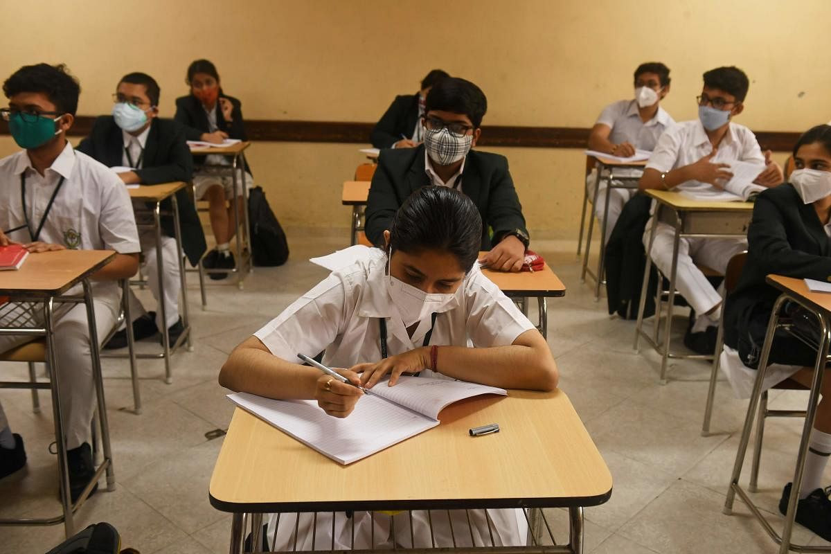 Schools students attend a class as the schools reopened after almost 11 months of break due to the Covid-19 pandemic. AFP