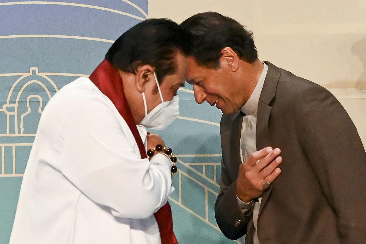 Pakistan's Prime Minister Imran Khan (R) and his Sri Lankan counterpart Mahinda Rajapaksa (L) gesture at the end of the Trade and Investments conference in Colombo on February 24, 2021 on the second day of Khan's official visit to Sri Lanka. Credit: AFP Photo