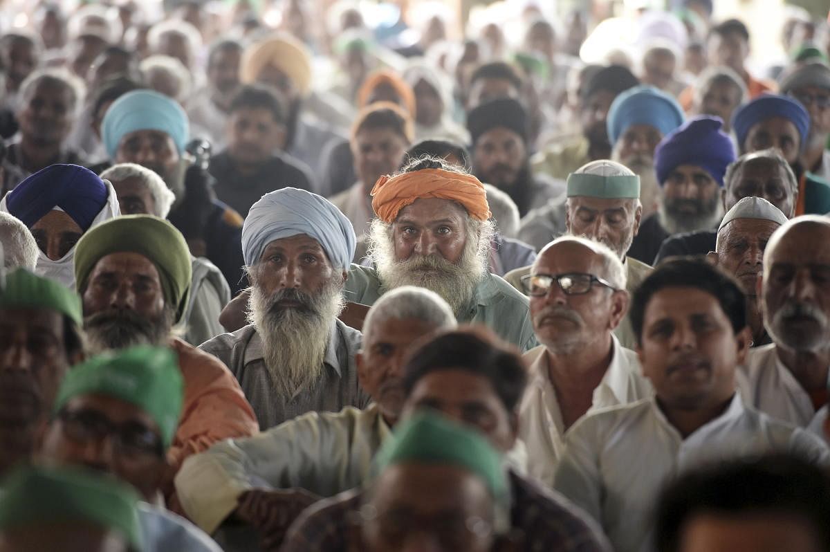 Farmers listen to speakers during their protest against the three new farm laws at Ghazipur border, in New Delhi, Saturday, Feb. 27, 2021. Credit: PTI Photo