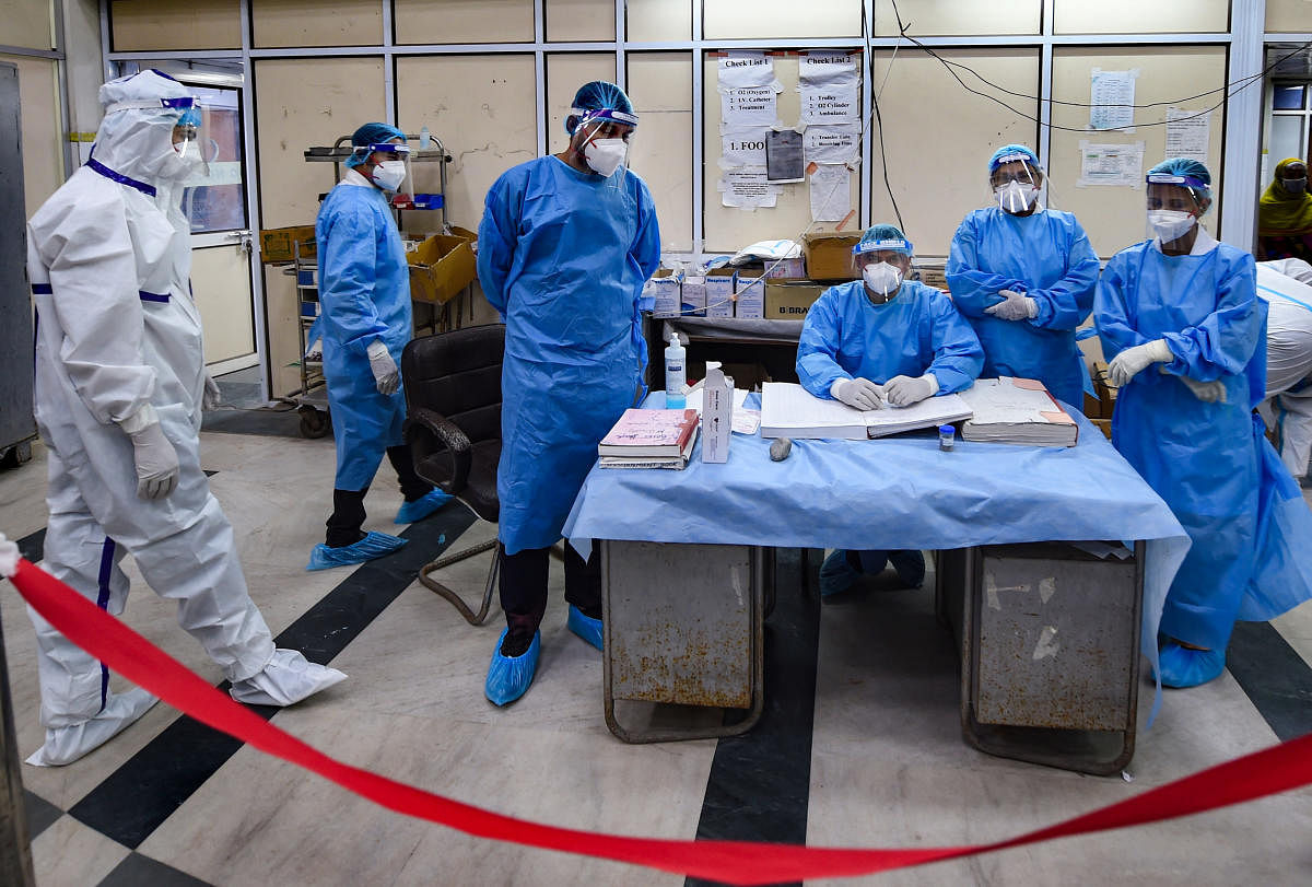 Medical staff who have been on Covid-19 duty since its outbreak, pose for a photographs at LNJP Hospital, in New Delhi. Credit: PTI Photo