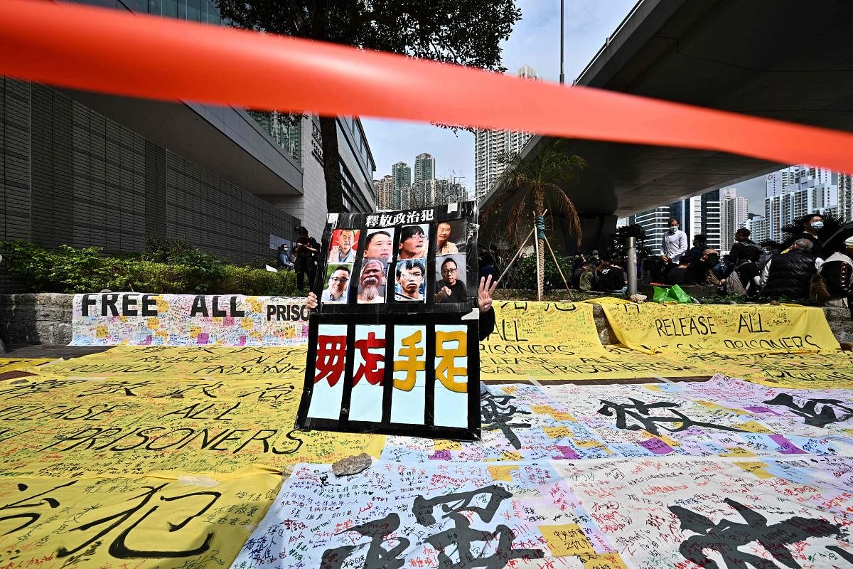 A supporter displays a placard outside the West Kowloon court in Hong Kong on March 1, 2021, ahead of court appearances by dozens of dissidents charged with subversion in the largest use yet of Beijing's sweeping new national security law. Credit: AFP Photo