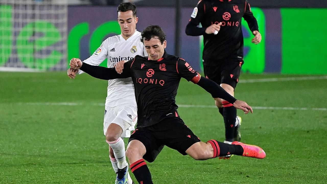 Real Madrid's Spanish forward Lucas Vazquez (L) challenges Real Sociedad's Spanish midfielder Mikel Oyarzabal during the La Liga match between Real Madrid CF and Real Sociedad. Credit: AFP Photo