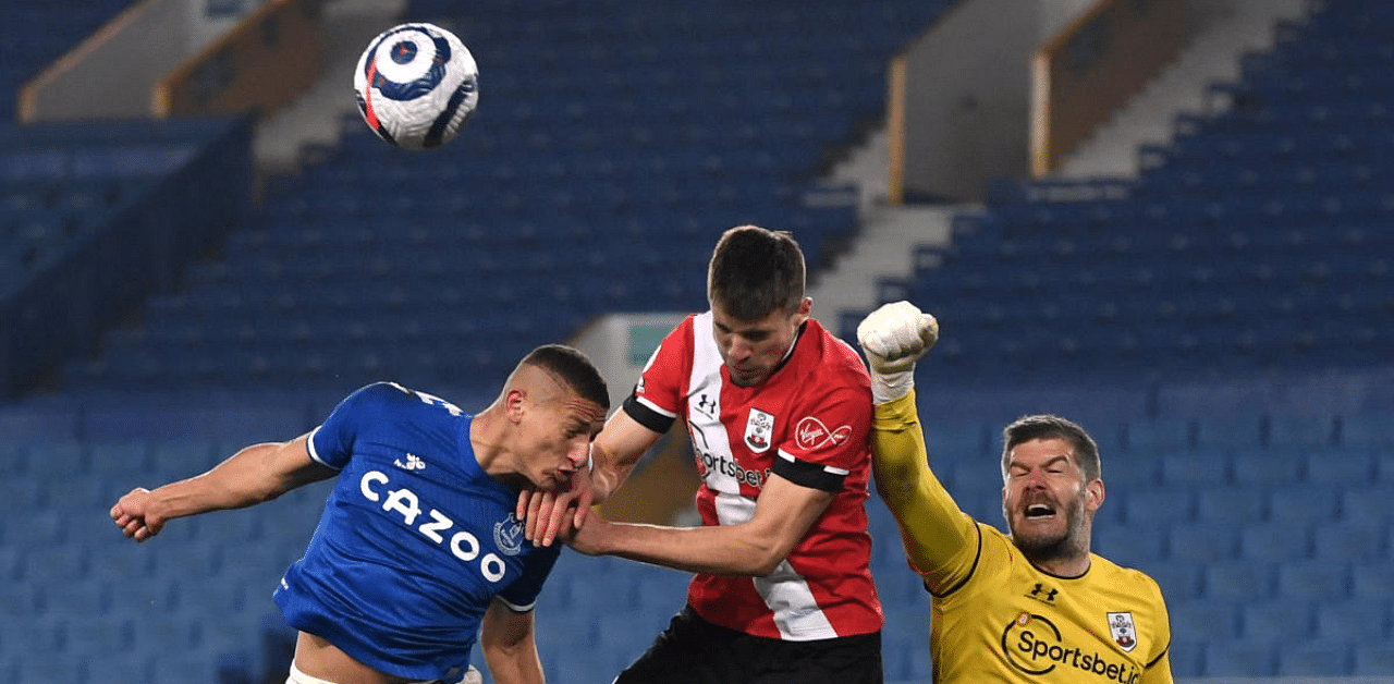 Everton's Richarlison in action with Southampton's Jan Bednarek and Fraser Forster. Credit: Reuters Photo
