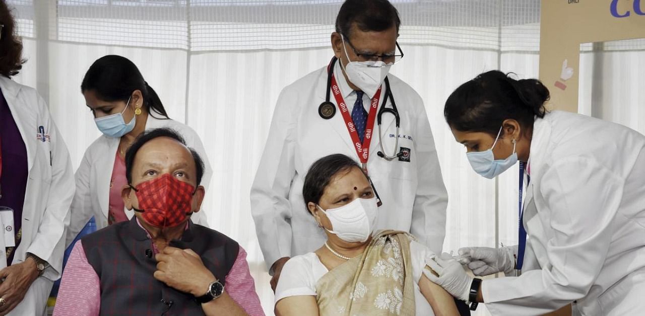 A medic administers the first dose of COVID-19 vaccine to Nutan Goel, wife of Union Health Minister Dr. Harsh Vardhan (L), during the second phase of a countrywide inoculation drive, at Delhi Heart and Lung Institute in New Delhi, Tuesday, March 2, 2021. Credit: PTI Photo