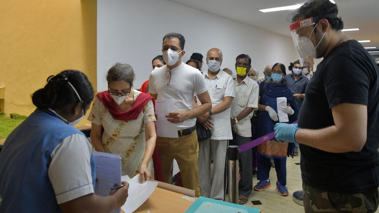 People queue up to register themselves to be inoculated with the Covid-19 coronavirus vaccine at MS Ramaiah Hospital in Bengaluru. Credit: AFP.
