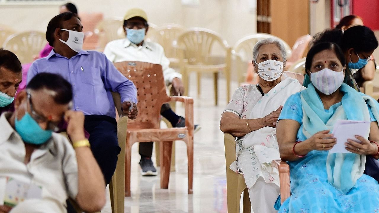 Senior citizens await to get inoculated with the Covid-19 coronavirus vaccine at Moti Lal Nehru Medical College in Allahabad on March 1, 2021, as India has opened up the jabs to all over-60s and any over-45s with serious illnesses. Credit: AFP Photo