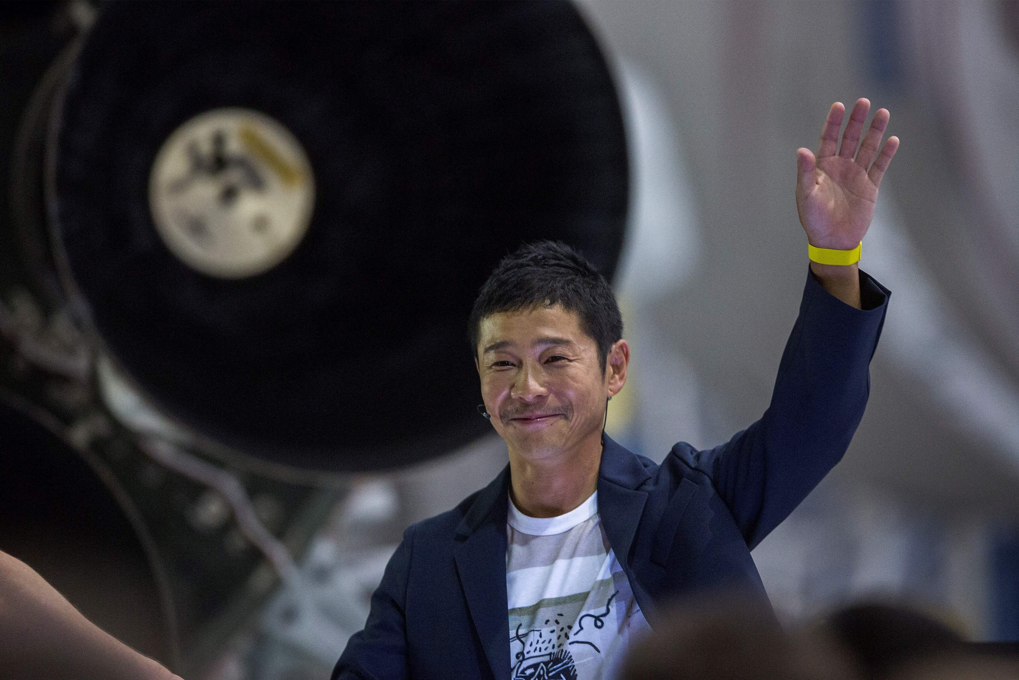 Japanese billionaire Yusaku Maezawa gesturing near a Falcon 9 rocket, during the announcement by Elon Musk for Maezawa to be the first private passenger who will fly around the Moon aboard the SpaceX BFR launch vehicle, at the SpaceX headquarters and rocket factory in Hawthorne, California. Credit: AFP File Photo