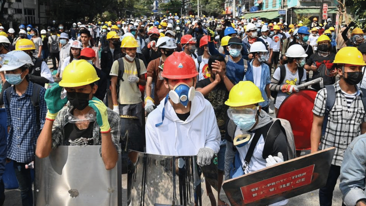 Protesters wearing protective gear gather on a road during a demonstration against the military coup in Yangon on March 3, 2021. Credit: AFP Photo