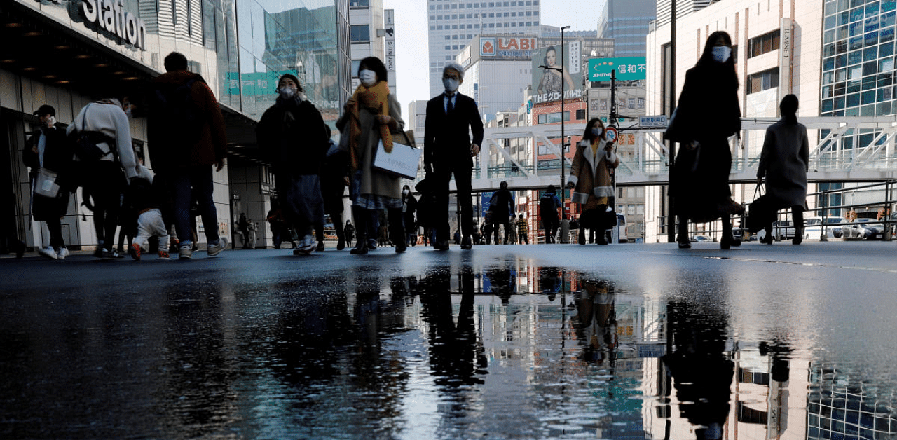 Pedestrians wearing protective masks amid the coronavirus disease outbreak, make their way in Tokyo. Credit: Reuters photo. 
