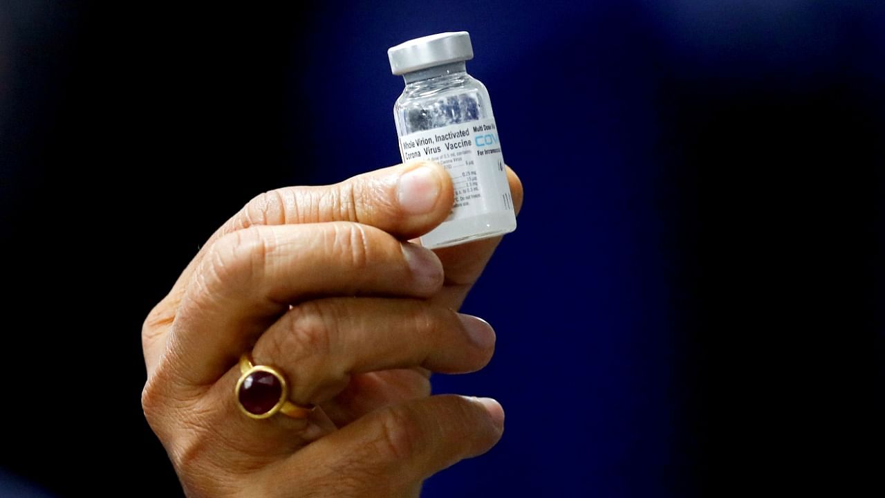 Health Minister Harsh Vardhan holds a dose of Bharat Biotech's Covid-19 vaccine called Covaxin, during a vaccination campaign at AIIMS hospital in New Delhi, India, January 16, 2021. Credit: Reuters File Photo 