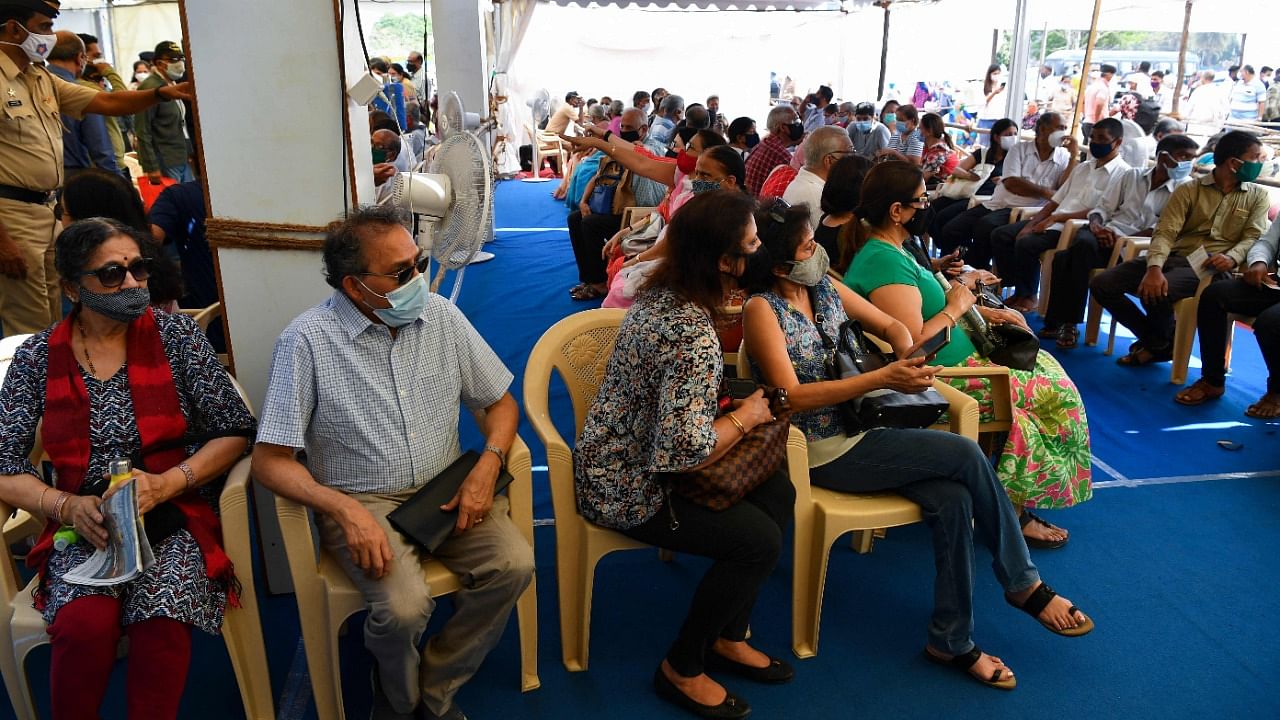 Senior citizens wait before being inoculated with a Covid-19 coronavirus vaccine at a vaccination centre in Mumbai on March 2, 2021, as the country begins a vaccination programme for senior people. Credit: AFP Photo