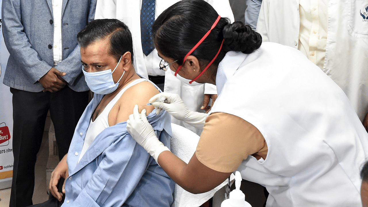 A medic administers the first dose of Covid-19 vaccine to Delhi Chief Minister Arvind Kejriwal, during the second phase of a countrywide inoculation drive. Credit: PTI Photo