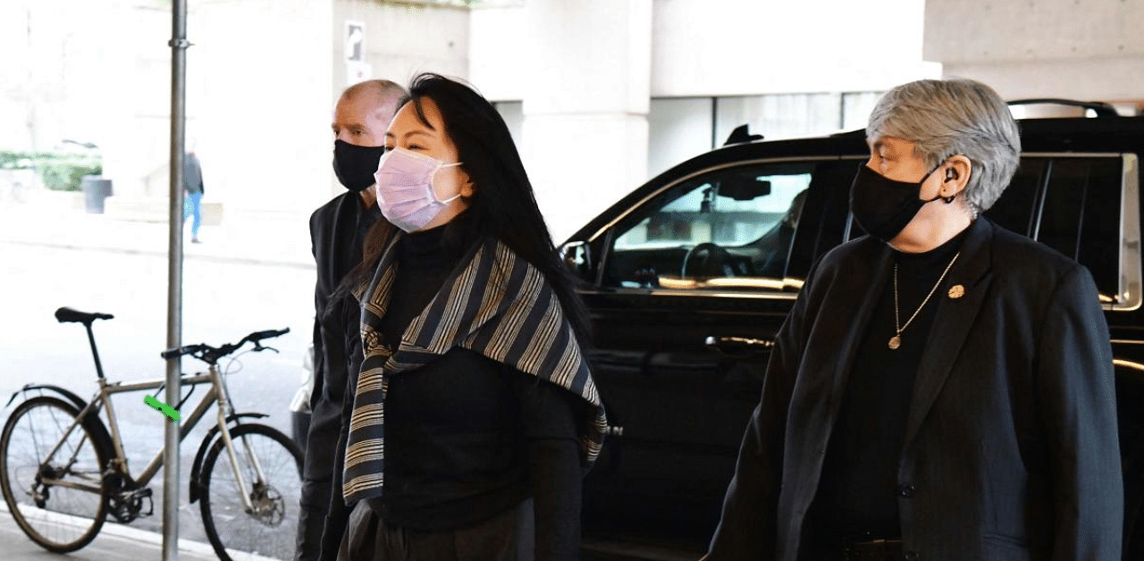 Huawei Chief Financial Officer, Meng Wanzhou,(C) arrives at British Columbia Supreme Court, with her security team in Vancouver, Canada. Credit: AFP Photo