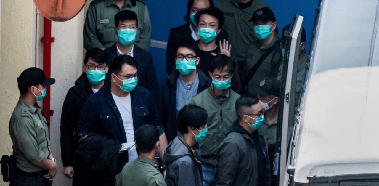 Hong Kong pro-democracy activists are escorted into a van as they leave the Lai Chi Kok Reception Centre. Credit: AFP Photo