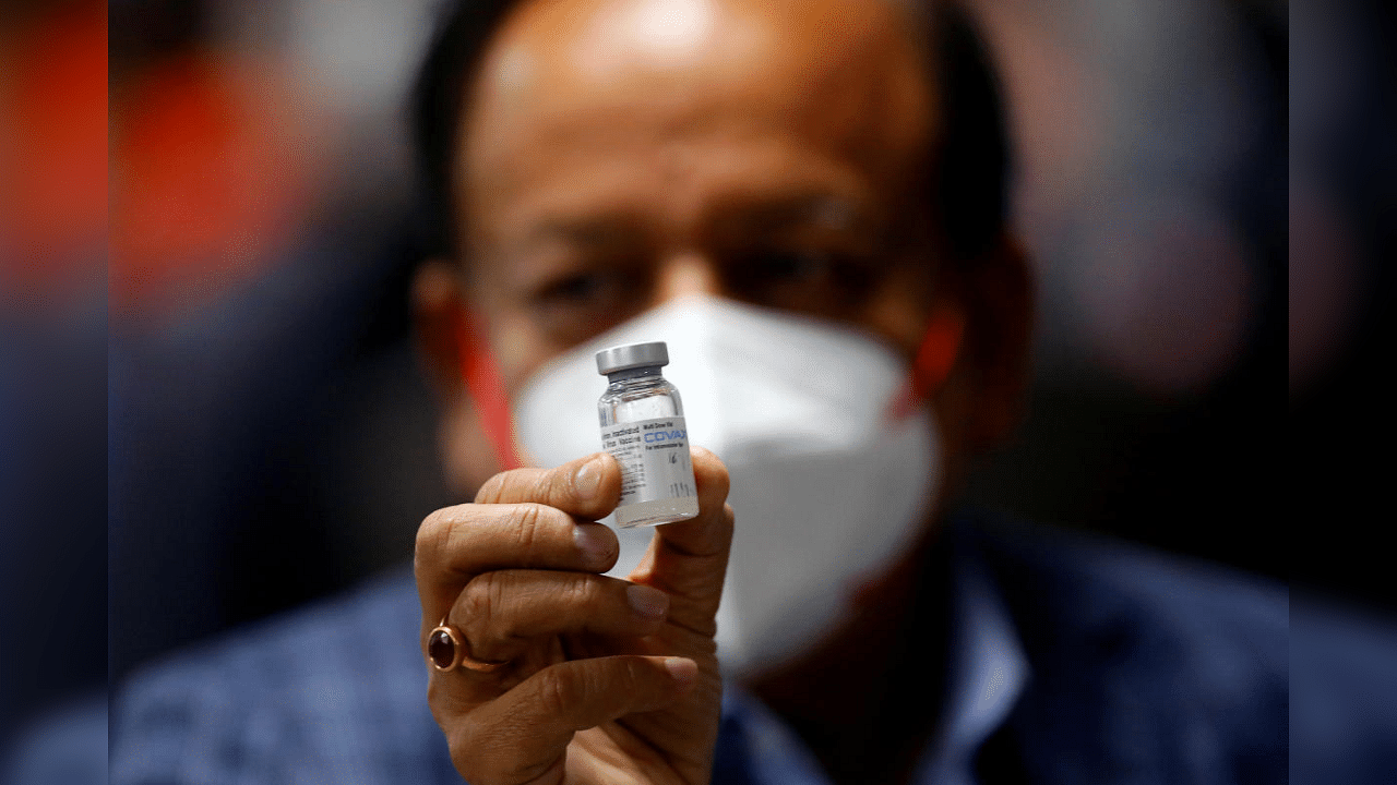 Union Health Minister Harsh Vardhan holds a dose of Bharat Biotech's Covid-19 vaccine called Covaxin, during a vaccination campaign at All India Institute of Medical Sciences (AIIMS) hospital in New Delhi, India, January 16, 2021. Credit: Reuters Photo