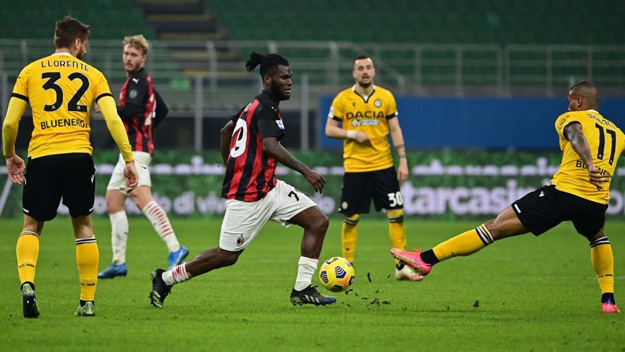 AC Milan's Ivorian midfielder Franck Kessie (C) challenges Udinese's Brazilian midfielder Walace during the Italian Serie A football match AC Milan vs Udinese. Credit: AFP.