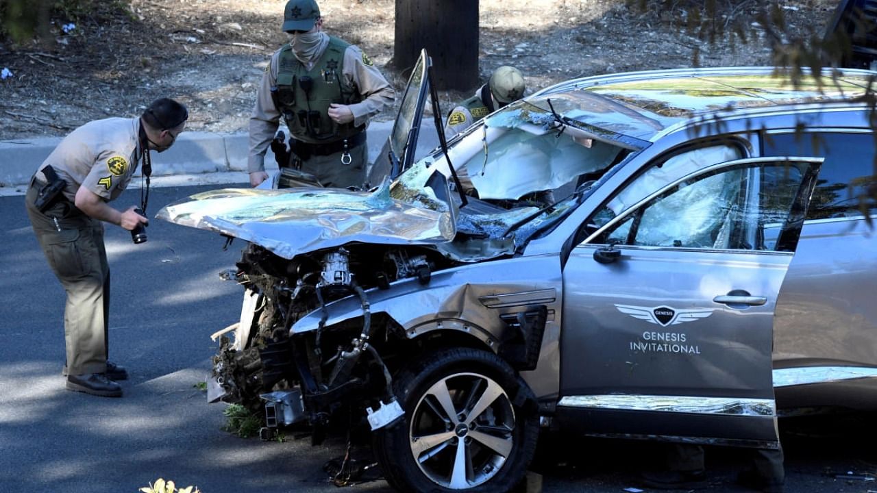  Los Angeles County Sheriff's Deputies inspect the vehicle of golfer Tiger Woods, who was rushed to hospital after suffering multiple injuries, after it was involved in a single-vehicle accident in Los Angeles. Credit: Reuters file photo.
