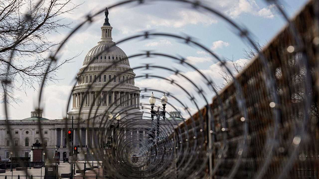 The US Capitol is seen through razor wire after police warned that a militia group might try to attack the US Capitol in Washington, US. Credit: Reuters Photo