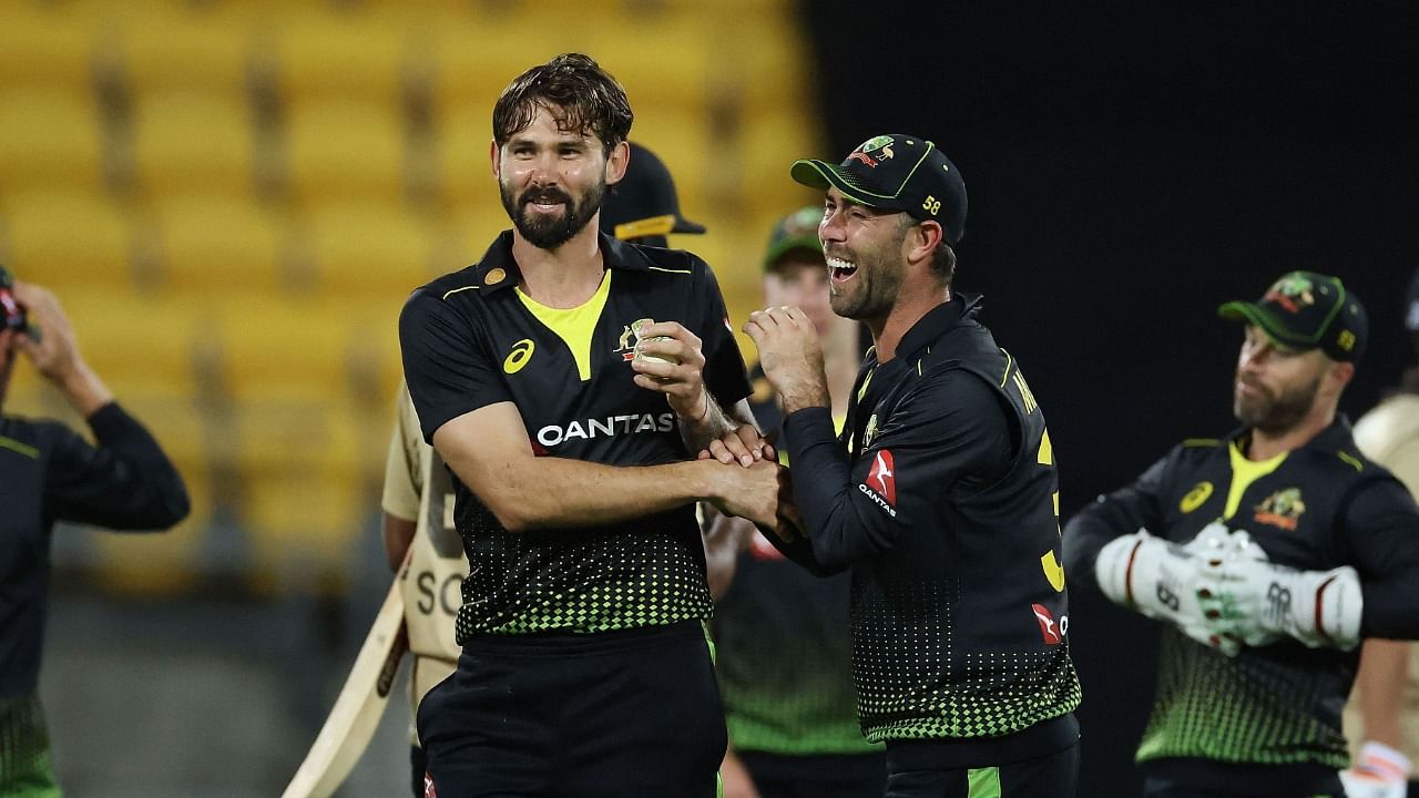 Australia's Kane Richardson (L) celebrates their win with teammate Glenn Maxwell during the third Twenty20 cricket match between New Zealand and Australia in Wellington on March 3, 2021. Credit: AFP File Photo