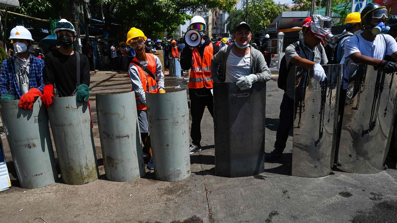 Protesters hold makeshift shields during a demonstration against the military coup in Yangon. Credit: AFP File Photo