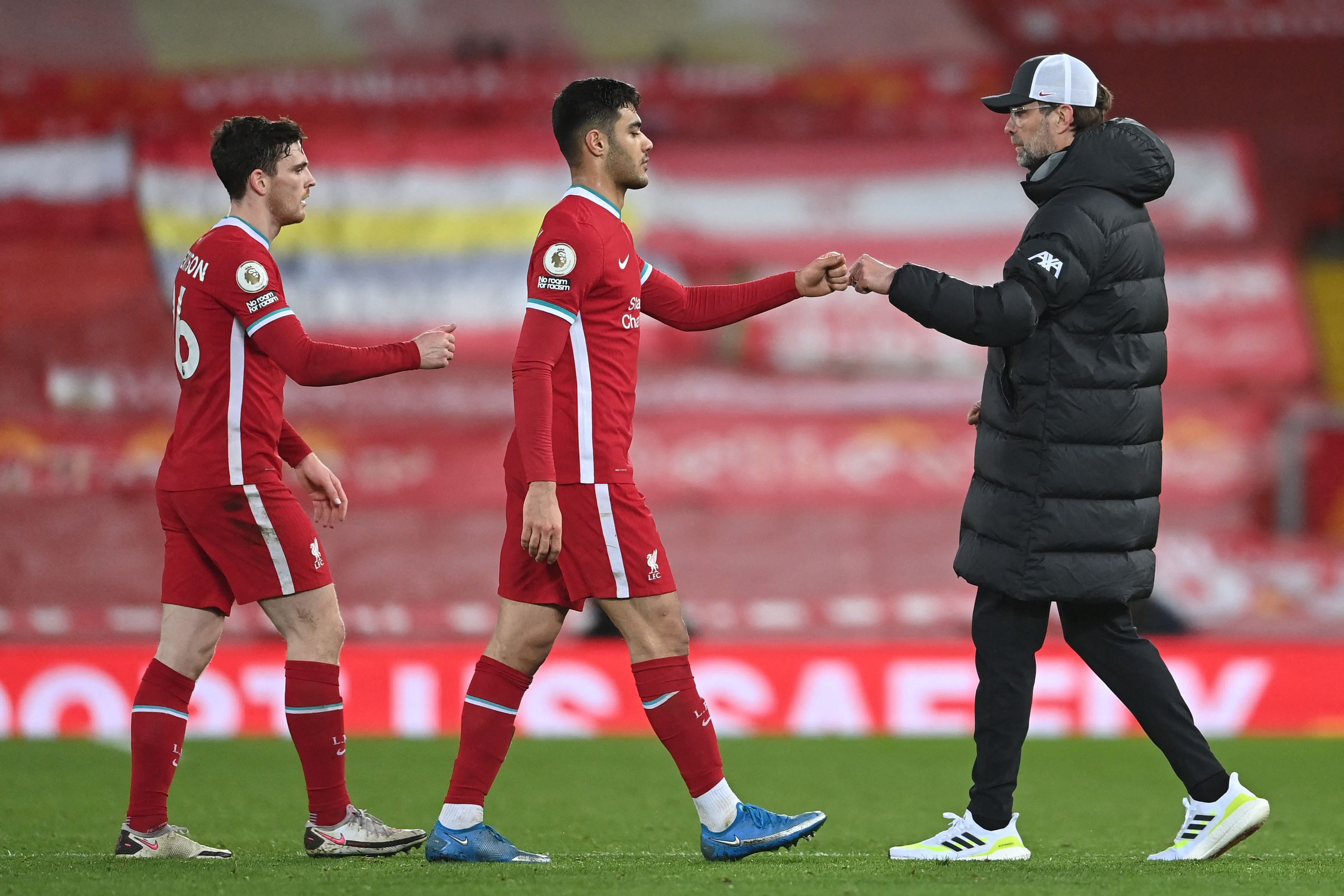 Liverpool's Scottish defender Andrew Robertson (L), Liverpool's Turkish defender Ozan Kabak (C) and Liverpool's German manager Jurgen Klopp react at the final whistle during the English Premier League football match between Liverpool and Chelsea at Anfield in Liverpool, north west England on March 4, 2021. Credit: AFP Photo