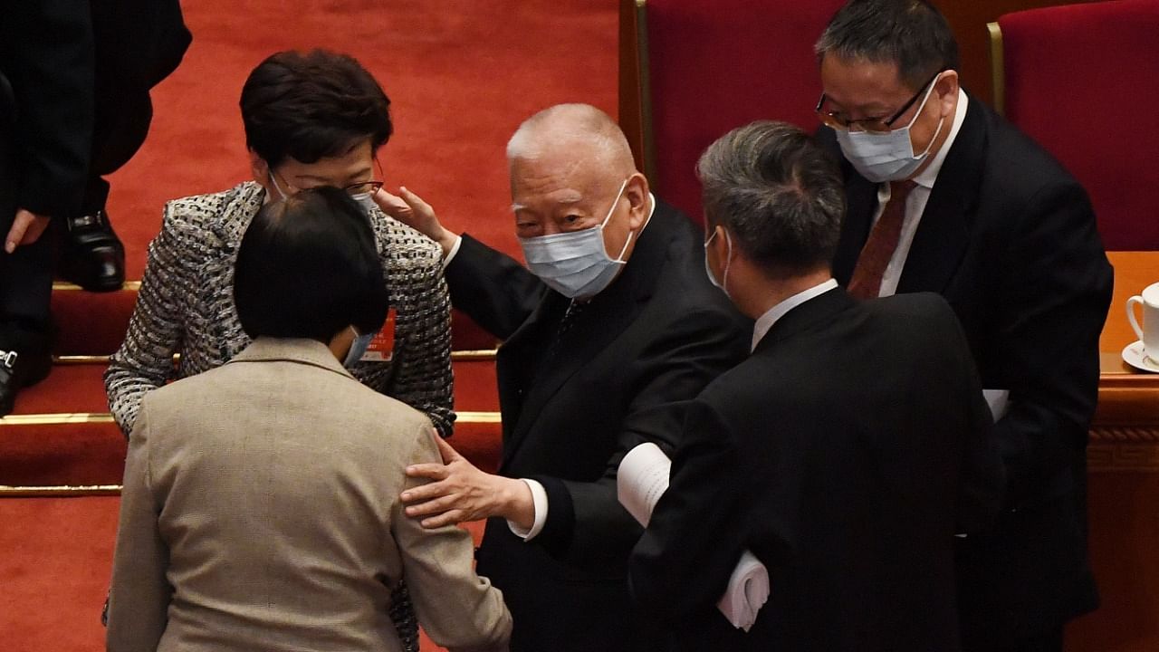 Former Hong Kong chief executive Tung Chee-hwa chats with Hong Kong Chief Executive Carrie Lam at the end of the opening session of the National People's Congress at the Great Hall of the People Credit: AFP Photo