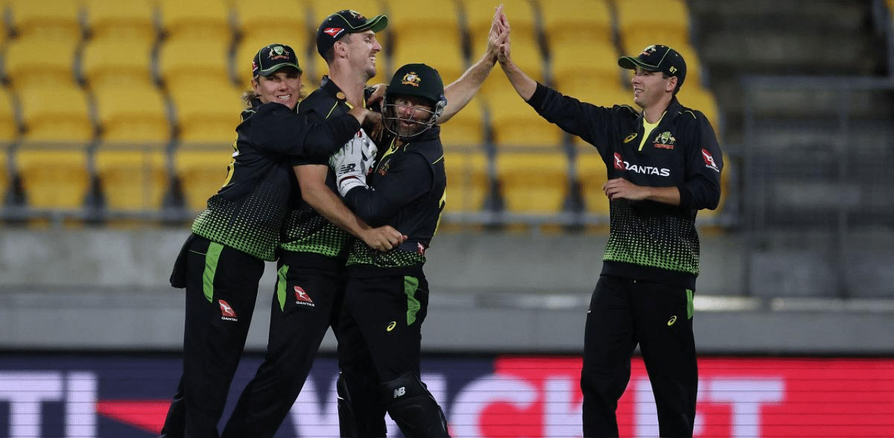 Australia's players celebrate the wicket of New Zealand's captain Kane Williamson during the fourth Twenty20 cricket match between New Zealand and Australia in Wellington. Credit: AFP photo. 