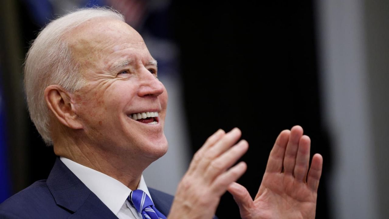 US President Joe Biden gestures while congratulating the NASA JPL Perseverance team on the successful Mars landing, inside the Roosevelt Room at the White House in Washington. Credit: Reuters.
