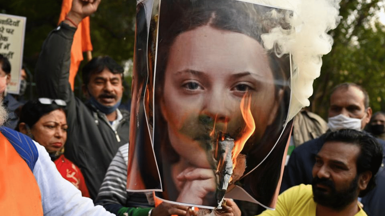 Activists of United Hindu Front (UHF) burn an effigy with a picture of Swedish climate activist Greta Thunberg during a demonstration in New Delhi on February 4, 2021, after she made comments on social media about mass farmers' protests in India.  Credit: AFP Photo