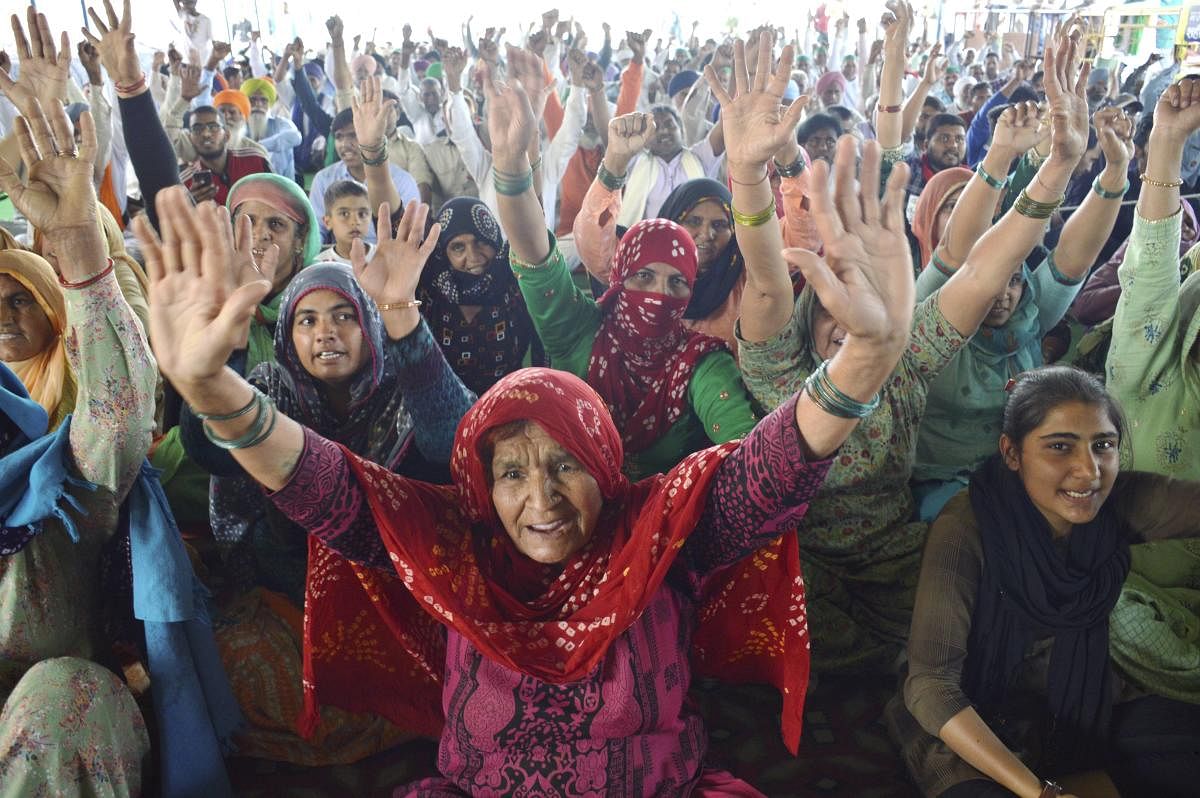 New Delhi: Farmers shout slogans during their ongoing protest against the new farm laws, at Ghazipur border in New Delhi, Friday, Feb. 26, 2021. Credit: PTI Photo