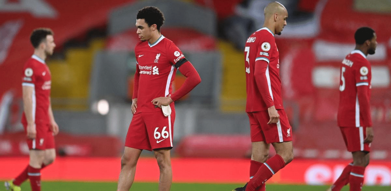 Liverpool's English defender Trent Alexander-Arnold (L) and Liverpool's Brazilian midfielder Fabinho react at the final whistle during the English Premier League football match between Liverpool and Chelsea at Anfield. Credit: AFP photo. 