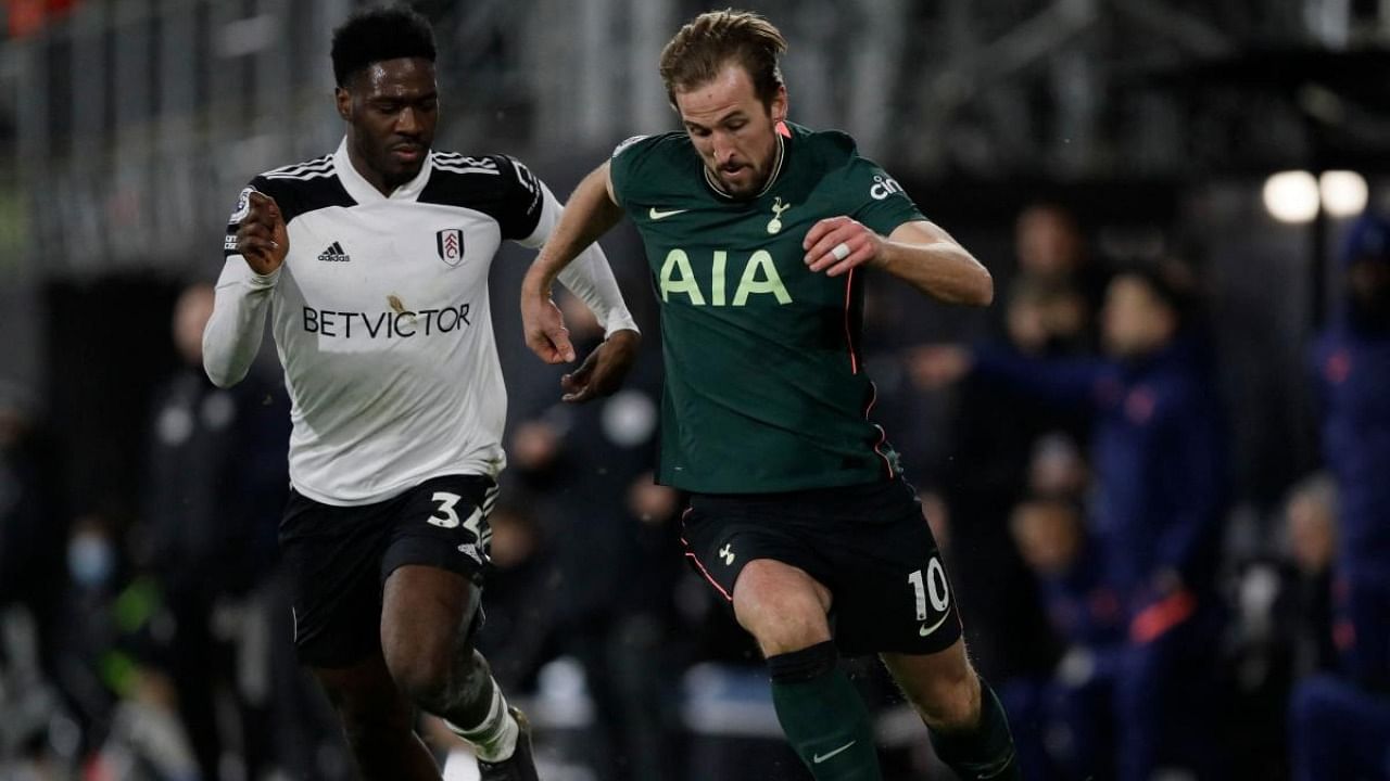 Tottenham Hotspur's English striker Harry Kane (R) vies with Fulham's Nigerian defender Ola Aina during the English Premier League football match between Fulham and Tottenham Hotspur at Craven Cottage in London. Credit: AFP.