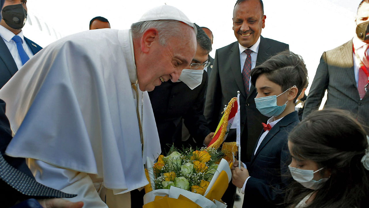 Pope Francis being greeted with flowers upon his arrival in the Iraqi shine city of Najaf, on March 6, 2021. Credit: Vatican News/AFP Photo