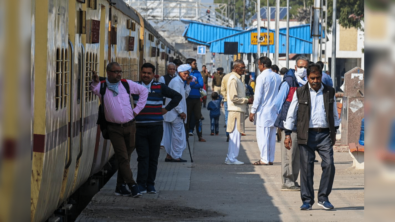 Stranded passengers wait on a railway platform during a four-hour rail blockade called by farmers protesting against the central government's recent agricultural reforms, at Ganaur railway station in Haryana on February 18, 2021. Credit: AFP Photo