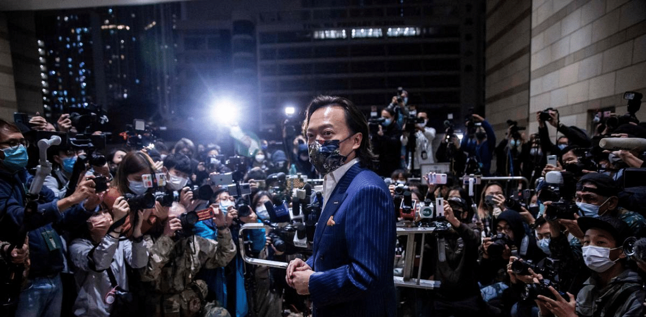 Lawyer Lawrence Lau (C) stands in front of the media outside West Kowloon court in Hong Kong on March 5, 2021, after being released on bail for the charge of “conspiracy to commit subversion”. Credit: AFP Photo