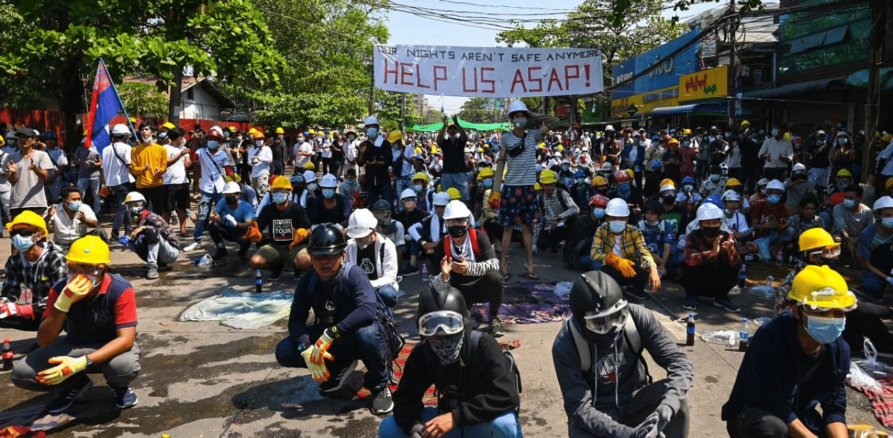 Protesters wear protective equipment as they prepare to face off against security forces during a demonstration against the military coup in Yangon. Credit: AFP Photo