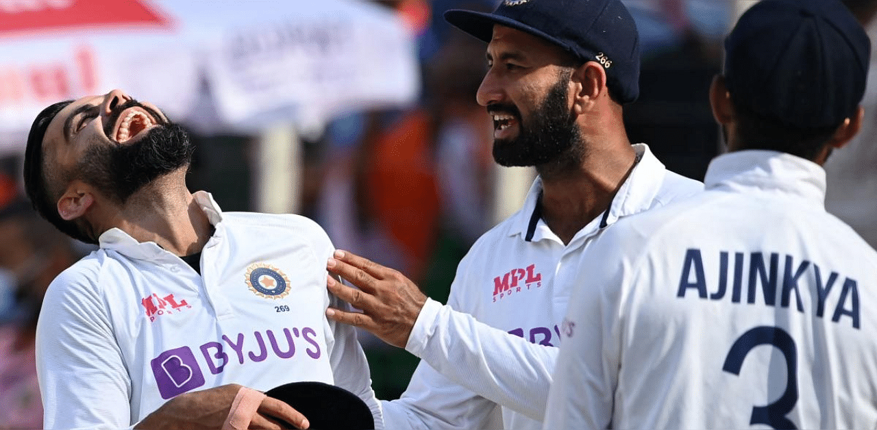 Virat Kohli (L) along with teammates celebrates their win on the third day of the fourth Test cricket match between India and England at the Narendra Modi Stadium in Motera. Credit: AFP photo. 