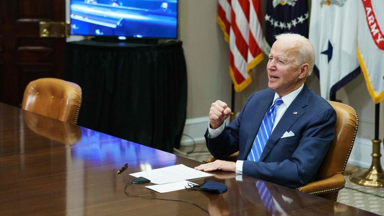 US President Joe Biden gestures as he speaks during a virtual call to congratulate the NASA JPL Perseverance team on the successful Mars landing, in the Roosevelt Room of the White House in Washington. Credit: AFP.