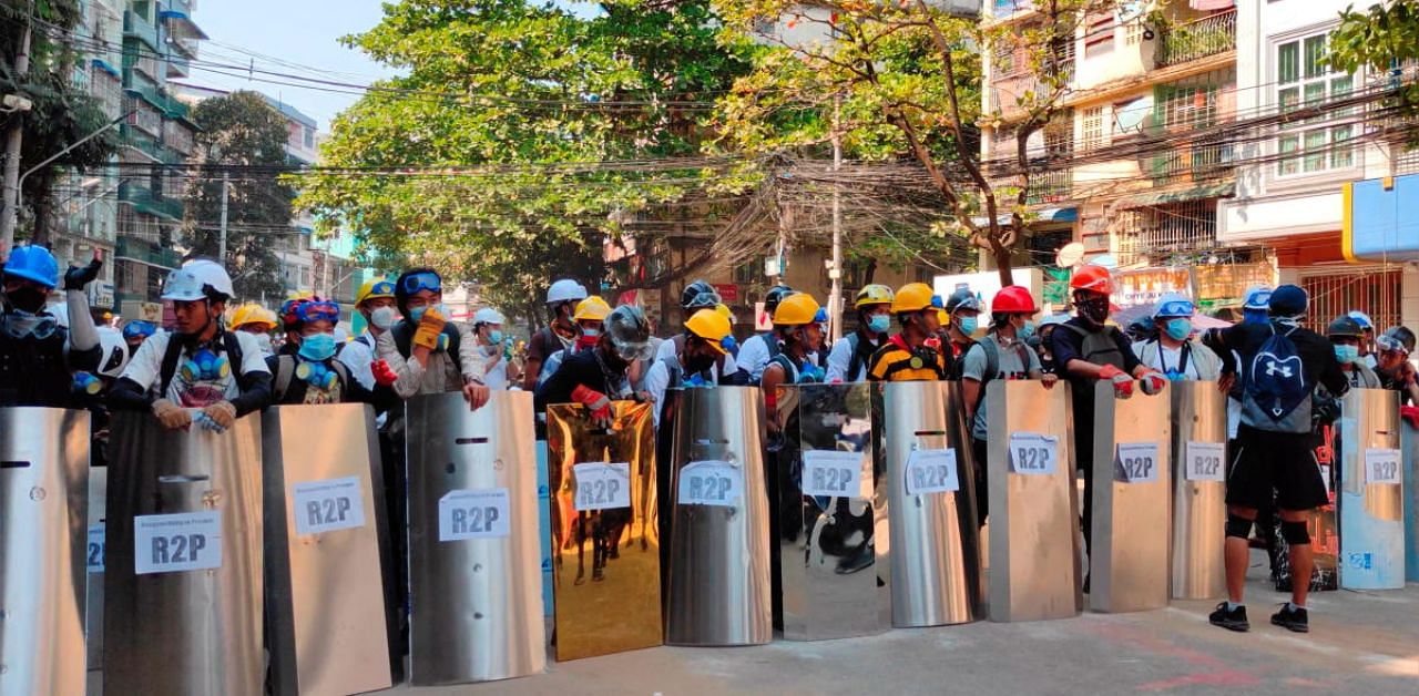 Protesters set up a makeshift shield formation in preparation for potential clashes, in Yangon, Myanmar. Credit: Reuters photo. 