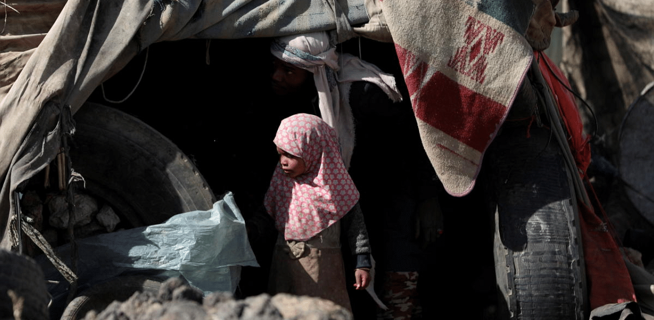 A girl stands outside her family's hut at a camp for internally displaced people on the outskirts of Sanaa, Yemen. Credit: Reuters photo. 